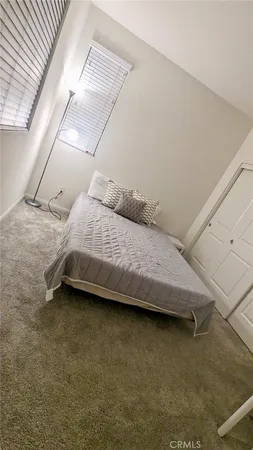 a bedroom with a bed and a night stand