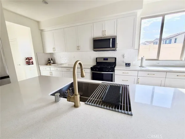 a kitchen with sink cabinets and window