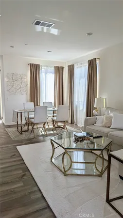 a room with furniture a large window and a chandelier