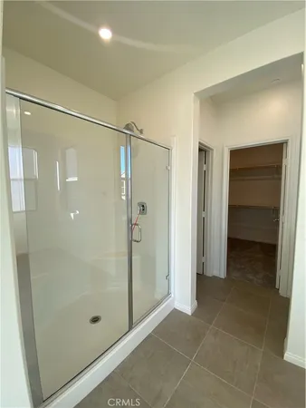 a bathroom with a shower and a glass door
