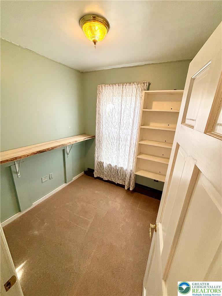 7241 Decatur Street New Tripoli, PA 18066 - Photo 20 of 36 A well-lit bedroom features built-in shelving and ample natural light through a window.