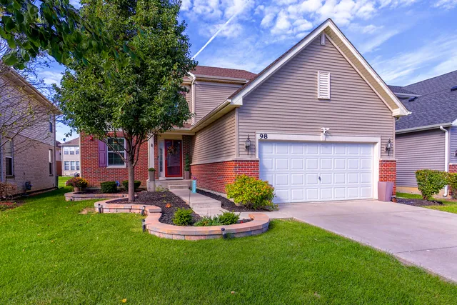 a front view of house with yard and green space