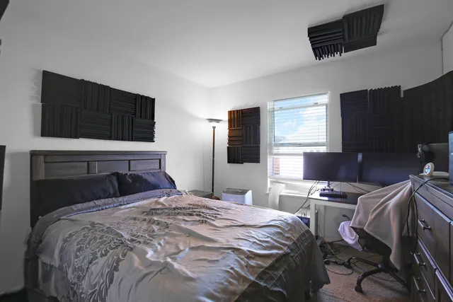 a bedroom with a bed and a television