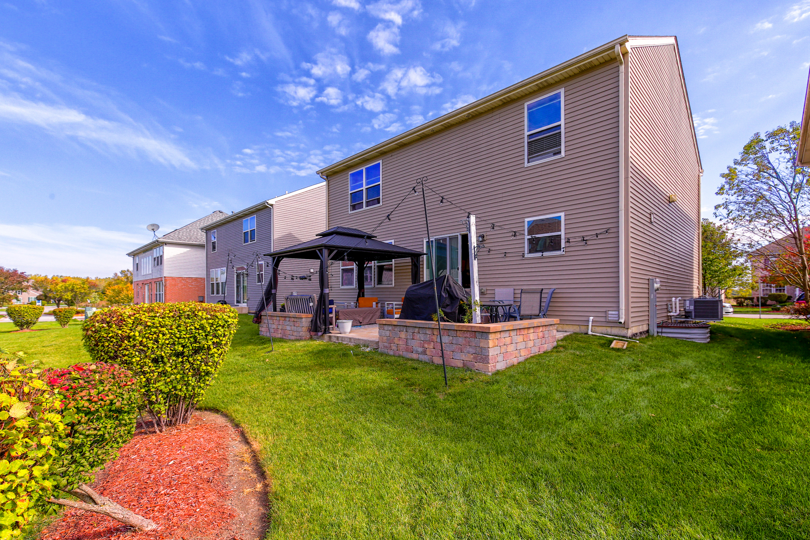 98 Lawrence Lane Matteson, IL 60443 - Photo 19 of 20 a front view of a house with a yard table and chairs