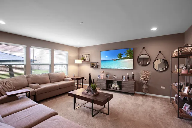a living room with furniture a rug and white walls