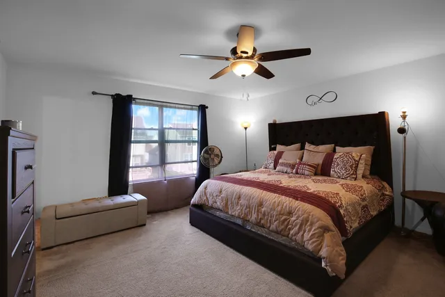 a bedroom with a bed and a window