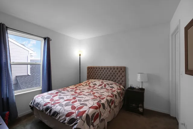 a bed sitting in a bedroom next to a window