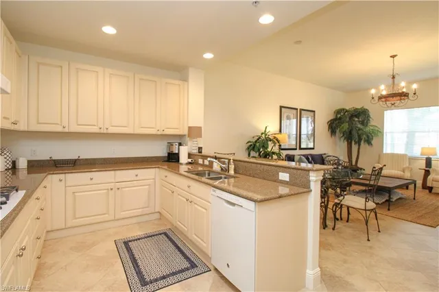 a kitchen with cabinets and chairs