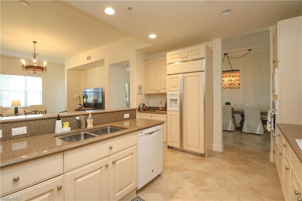 2713 Callista Court, Unit 103 Naples, FL 34114 - Photo 13 of 47 a bathroom with a double vanity sink a mirror and a shower