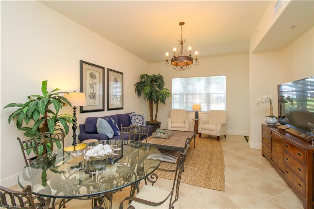 2713 Callista Court, Unit 103 Naples, FL 34114 - Photo 15 of 47 a living room with furniture and a chandelier