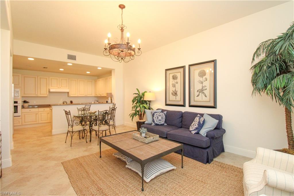 2713 Callista Court, Unit 103 Naples, FL 34114 - Photo 17 of 47 a living room with furniture and a chandelier