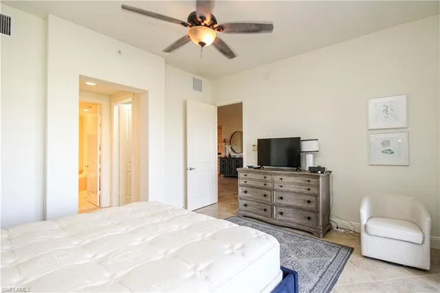 a bedroom with a bed and a television