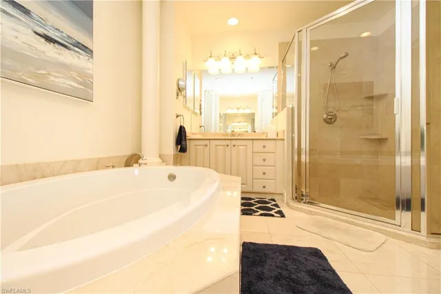 a bathroom with a tub a sink and a shower