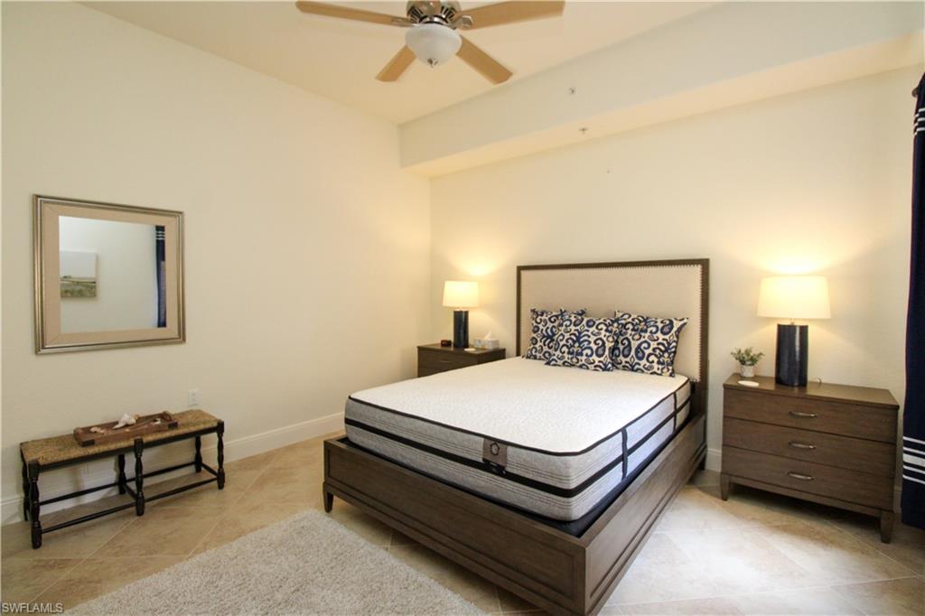2713 Callista Court, Unit 103 Naples, FL 34114 - Photo 33 of 47 a bed room with a bed and a ceiling fan