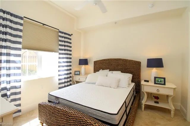 a bedroom with a bed and a night stand