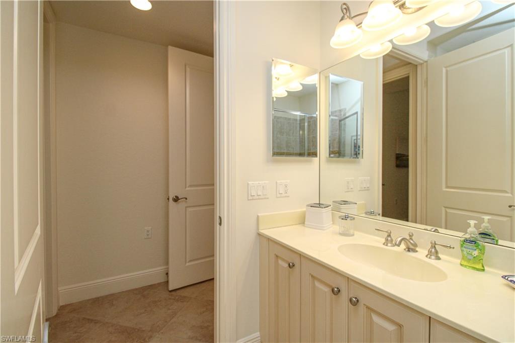2713 Callista Court, Unit 103 Naples, FL 34114 - Photo 39 of 47 a bathroom with a sink and a mirror