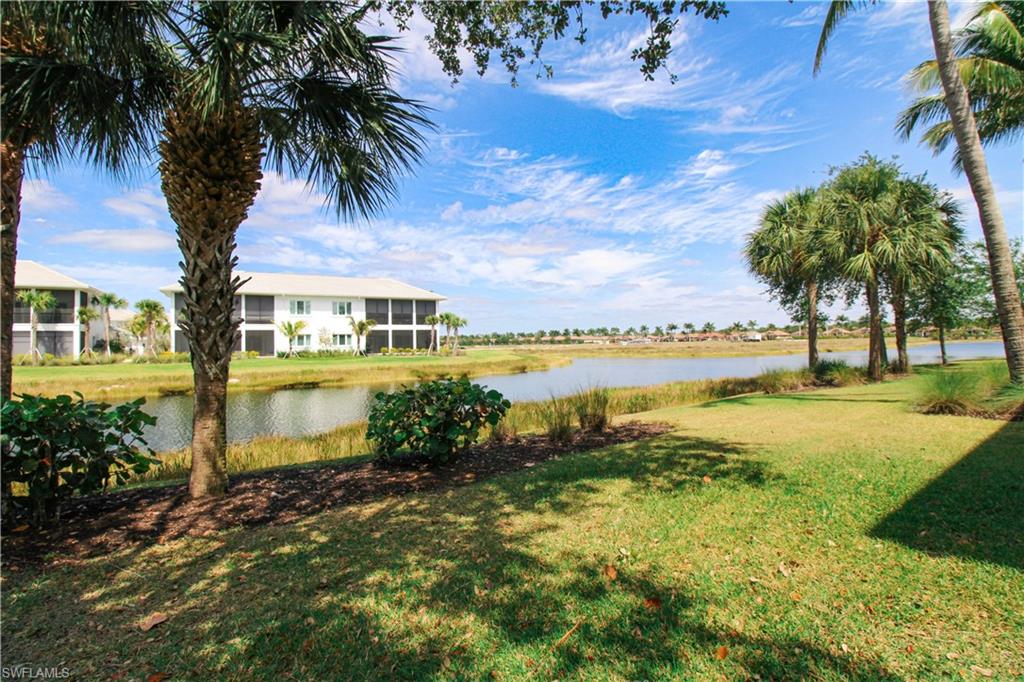 2713 Callista Court, Unit 103 Naples, FL 34114 - Photo 5 of 47 a view of a lake with a building in the background