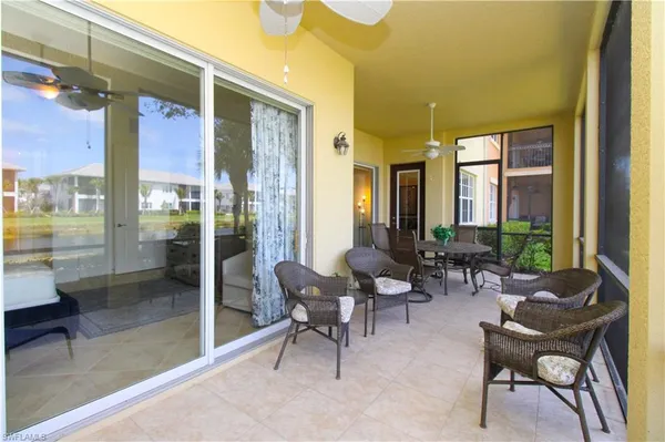 a living room with furniture and a floor to ceiling window