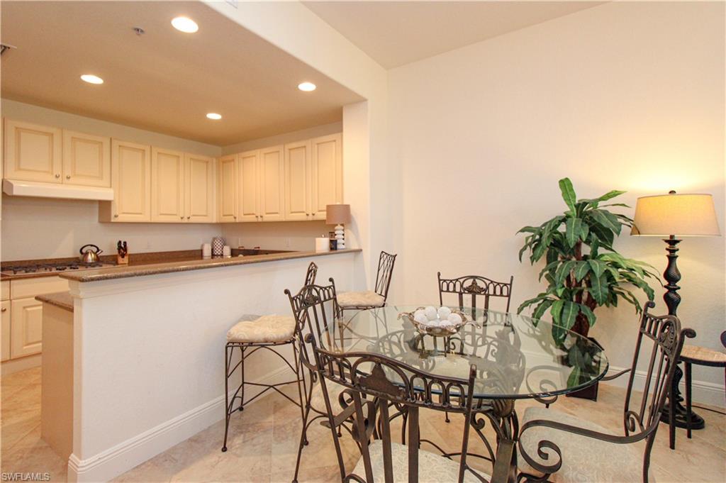 2713 Callista Court, Unit 103 Naples, FL 34114 - Photo 9 of 47 a kitchen with a table and chairs in it