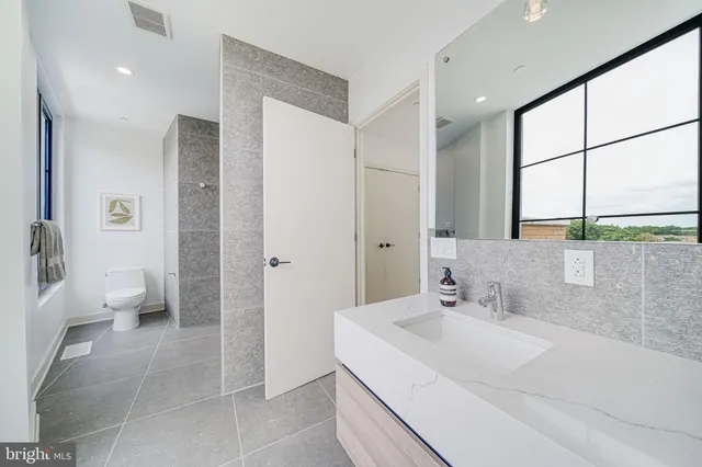 a bathroom with a sink and a large mirror