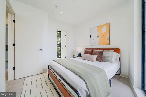 a bedroom with a bed and painting on the wall