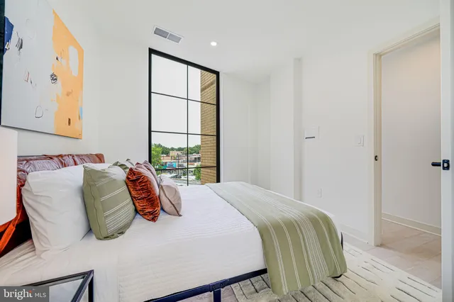 a bedroom with a bed and window