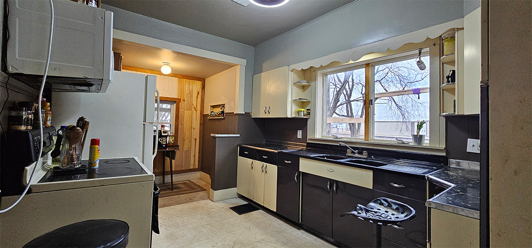 1002 Locust Street Thomson, IL 61285 - Photo 2 of 7 a kitchen with stainless steel appliances a stove a sink and a refrigerator
