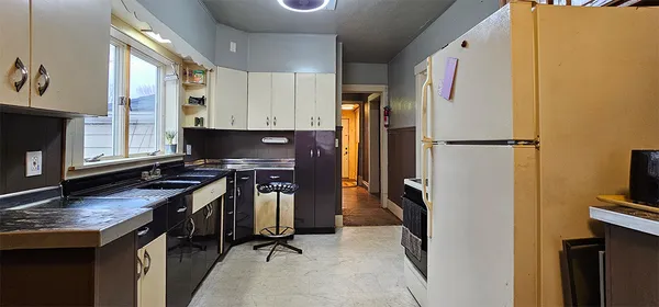 a kitchen with stainless steel appliances granite countertop a refrigerator a stove and a sink