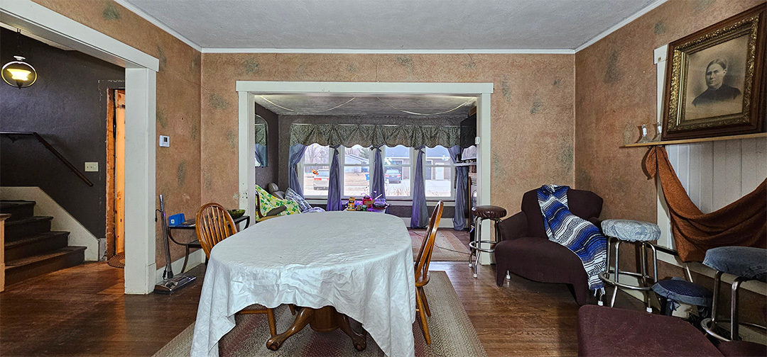 1002 Locust Street Thomson, IL 61285 - Photo 4 of 7 a living room with furniture a fireplace and a floor to ceiling window