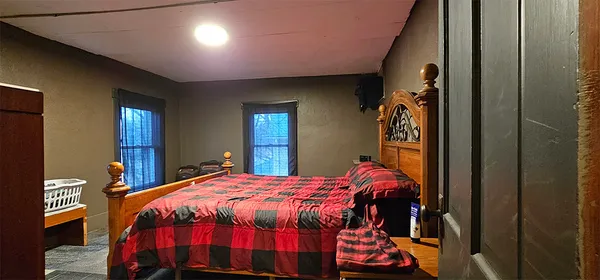 a bedroom with a bed and a lamp