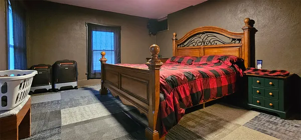 a bedroom with a bed and a dresser