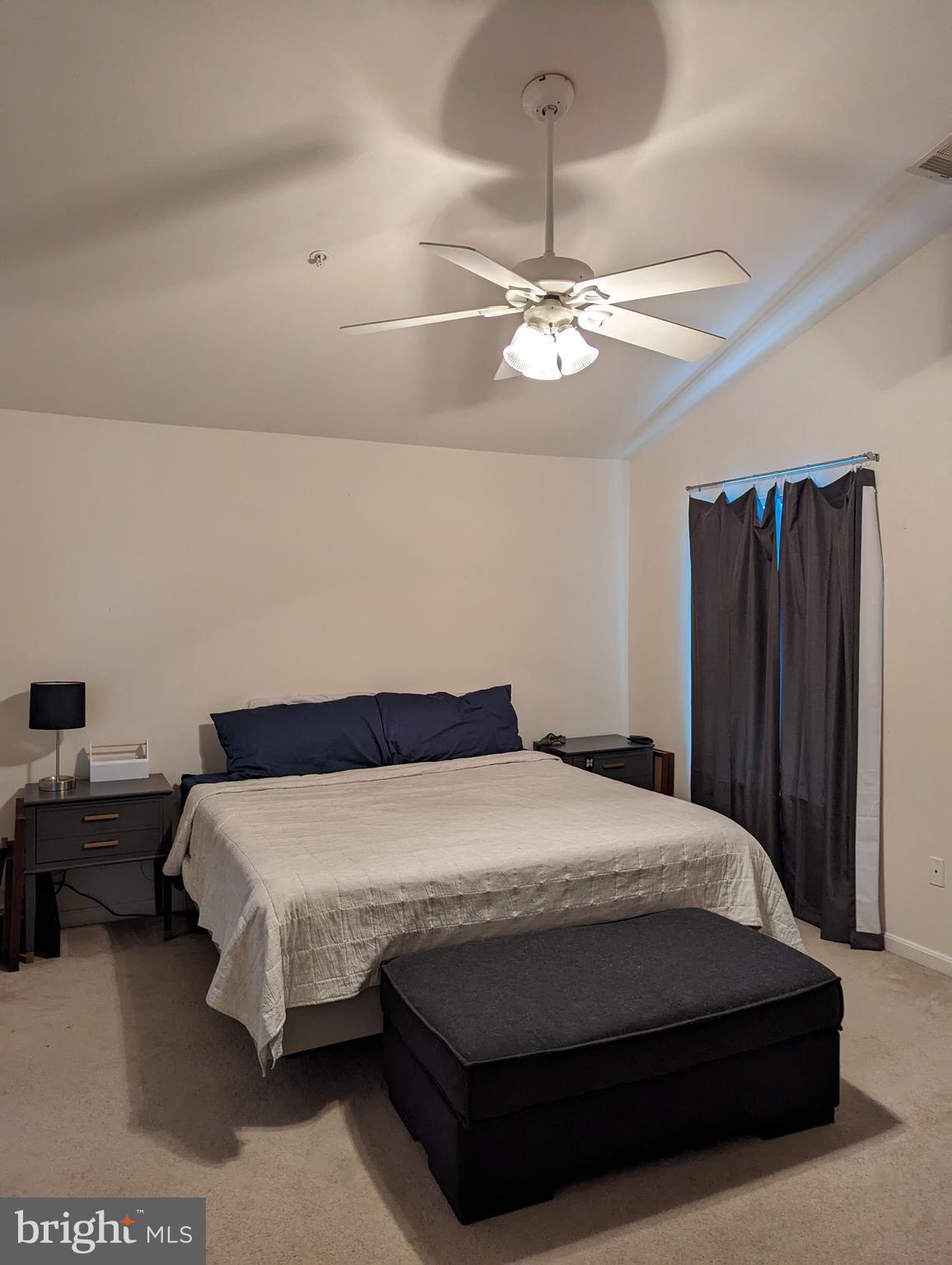 2701 Summers Ridge Drive Odenton, MD 21113 - Photo 21 of 50 a bedroom with a bed ceiling fan and a wooden headboard