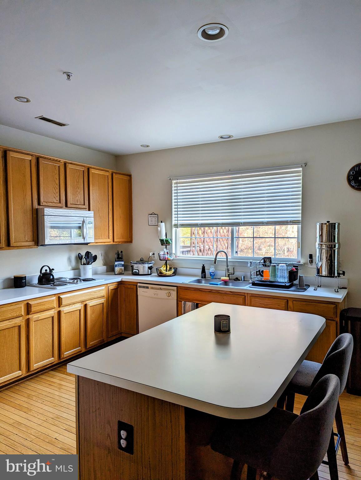 2701 Summers Ridge Drive Odenton, MD 21113 - Photo 8 of 50 a kitchen with stainless steel appliances granite countertop a sink a stove a kitchen island a stove a table and chairs