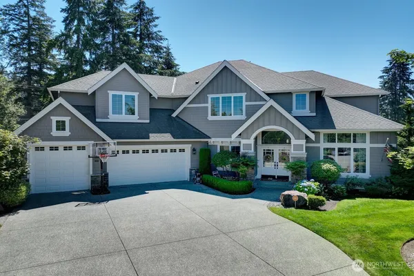 a front view of a house with a yard and garage