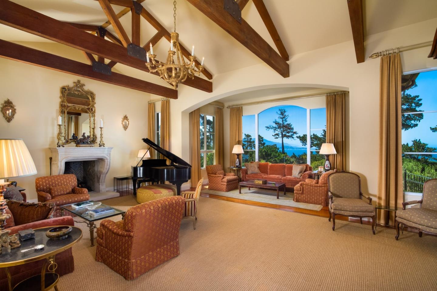 Padre Lane Pebble Beach, CA 93953 - Photo 4 of 25 a living room with furniture a fireplace and a large window