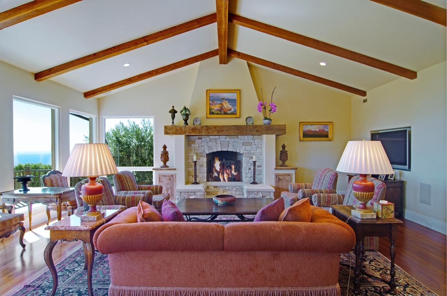 Padre Lane Pebble Beach, CA 93953 - Photo 5 of 25 a living room with furniture a fireplace and a large mirror