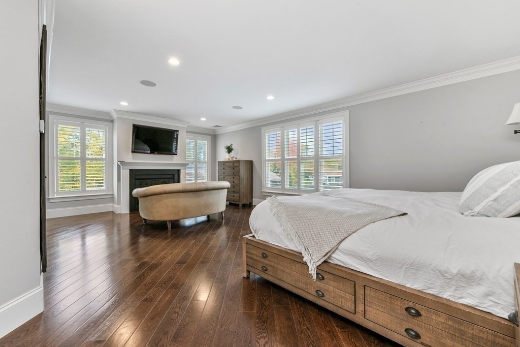 4 Fox Run Way Hingham, MA 02043 - Photo 14 of 34 a spacious bedroom with a bed and a flat screen tv