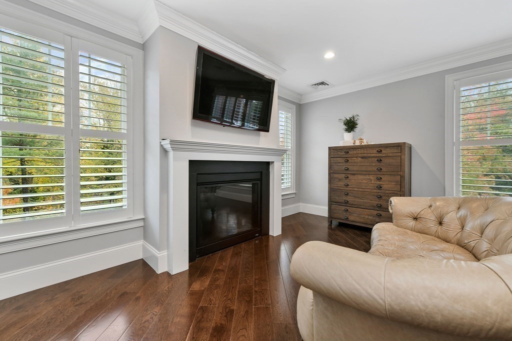 4 Fox Run Way Hingham, MA 02043 - Photo 15 of 34 a living room with furniture a flat screen tv and a fireplace