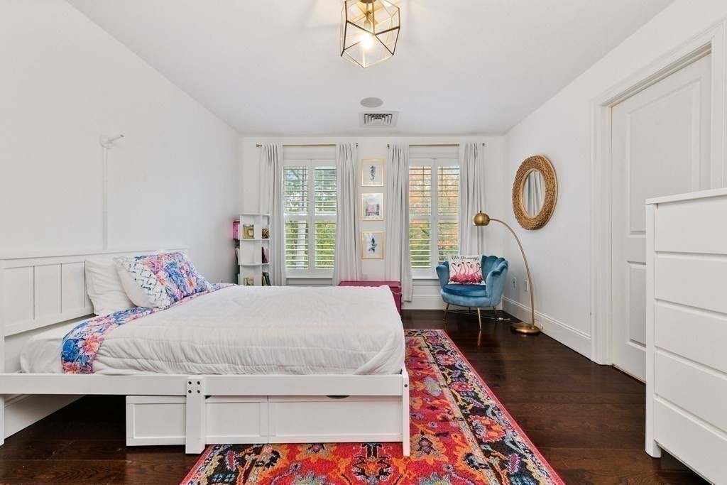 4 Fox Run Way Hingham, MA 02043 - Photo 20 of 34 a bedroom with a bed and a chandelier