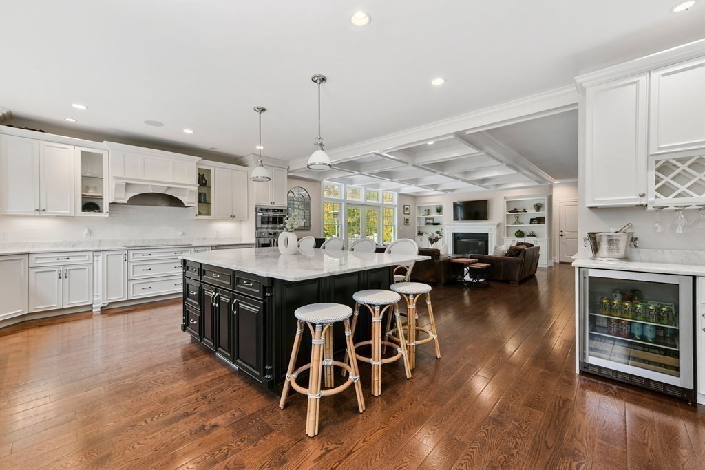 4 Fox Run Way Hingham, MA 02043 - Photo 4 of 34 a open kitchen with stainless steel appliances granite countertop a stove a sink dishwasher a dining table and chairs with wooden floor