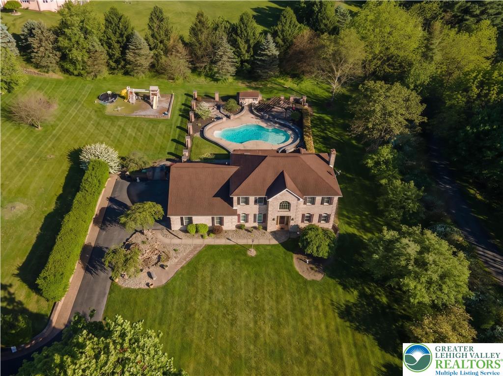 2170 Clearview Road Coplay, PA 18037 - Photo 6 of 75 An aerial view captures a stately home with a swimming pool and expansive grounds.