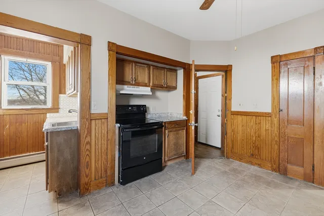 a kitchen with a refrigerator and a stove top oven