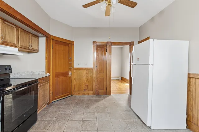a view of a kitchen with a sink and refrigerator