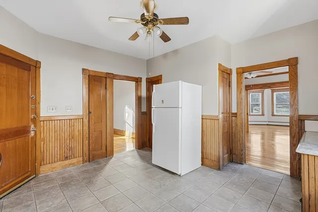 a view of a kitchen with refrigerator and cabinet
