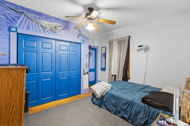 a bedroom with a bed and a closet