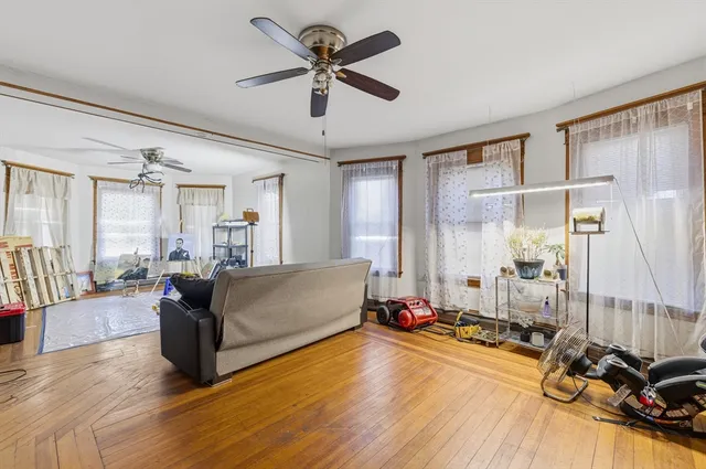 a very nice looking room with many windows and furniture