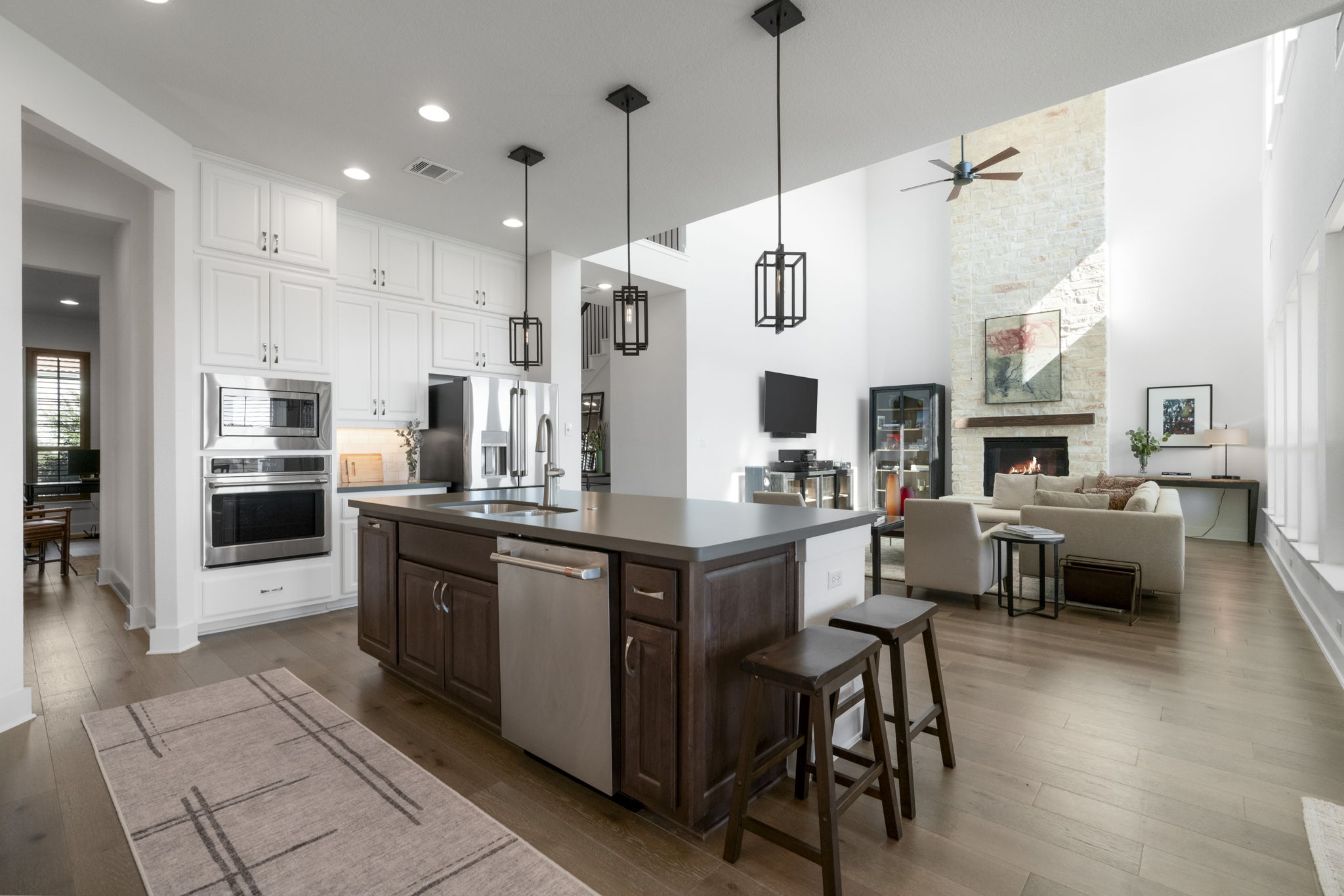 4704 Montorio Way Leander, TX 78641 - Photo 39 of 40 a large kitchen with stainless steel appliances kitchen island granite countertop a table chairs and a refrigerator