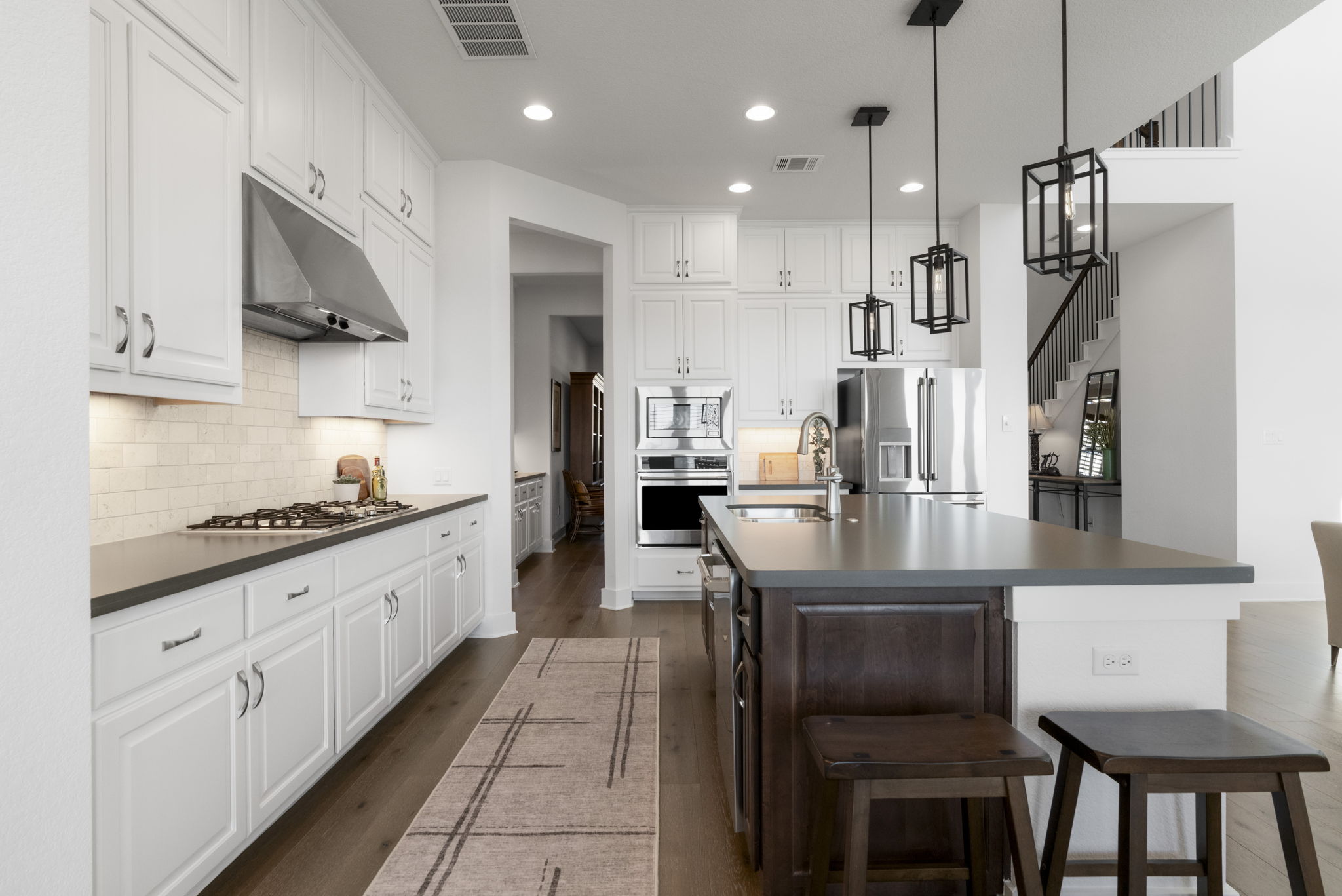 4704 Montorio Way Leander, TX 78641 - Photo 12 of 40 a kitchen with stainless steel appliances granite countertop a sink a stove and a refrigerator
