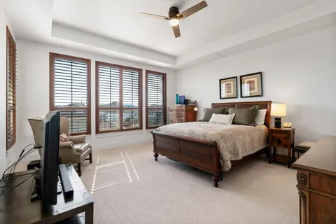 a bedroom with a bed and a desk