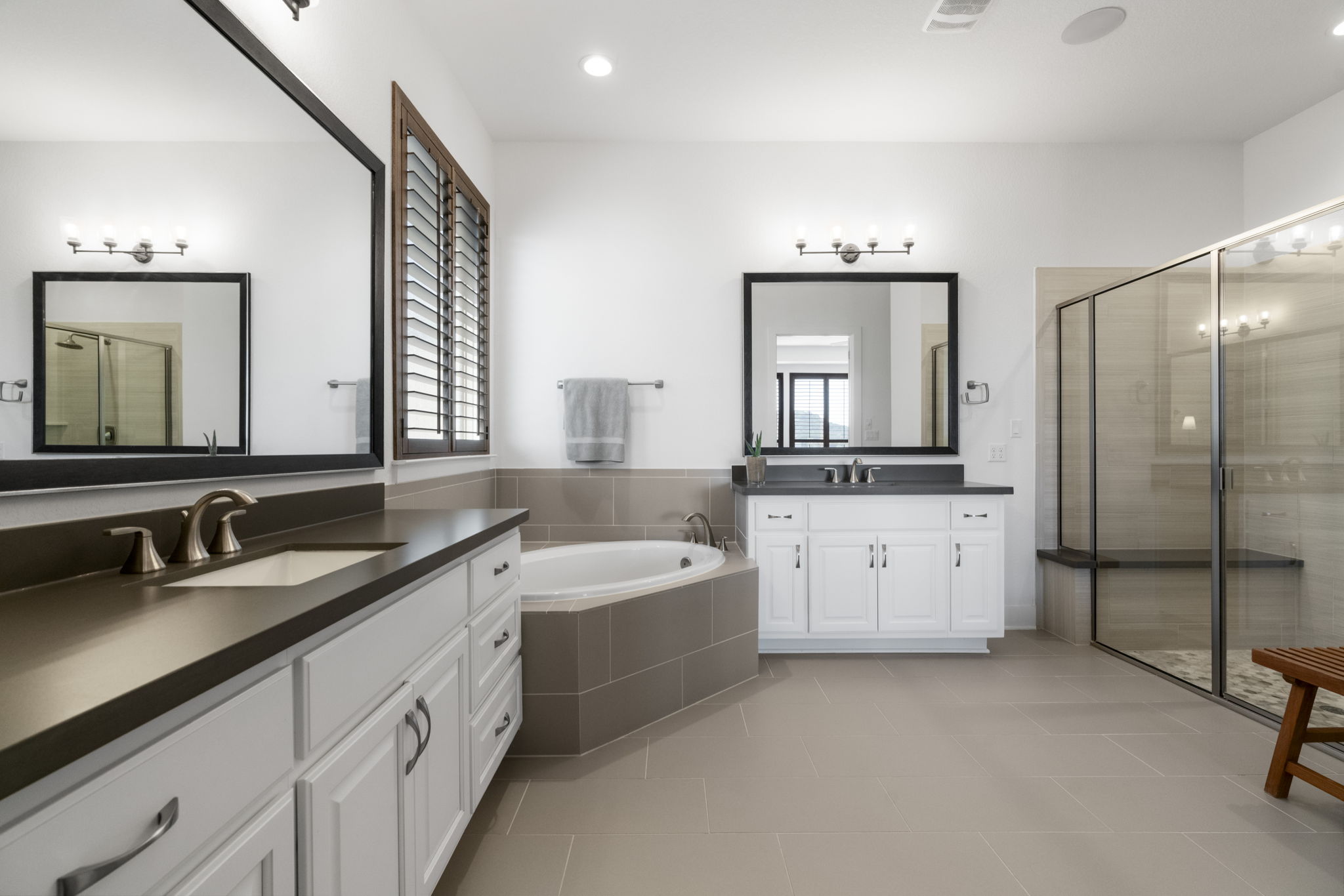 4704 Montorio Way Leander, TX 78641 - Photo 18 of 40 a bathroom with a double vanity sink mirror and bathtub